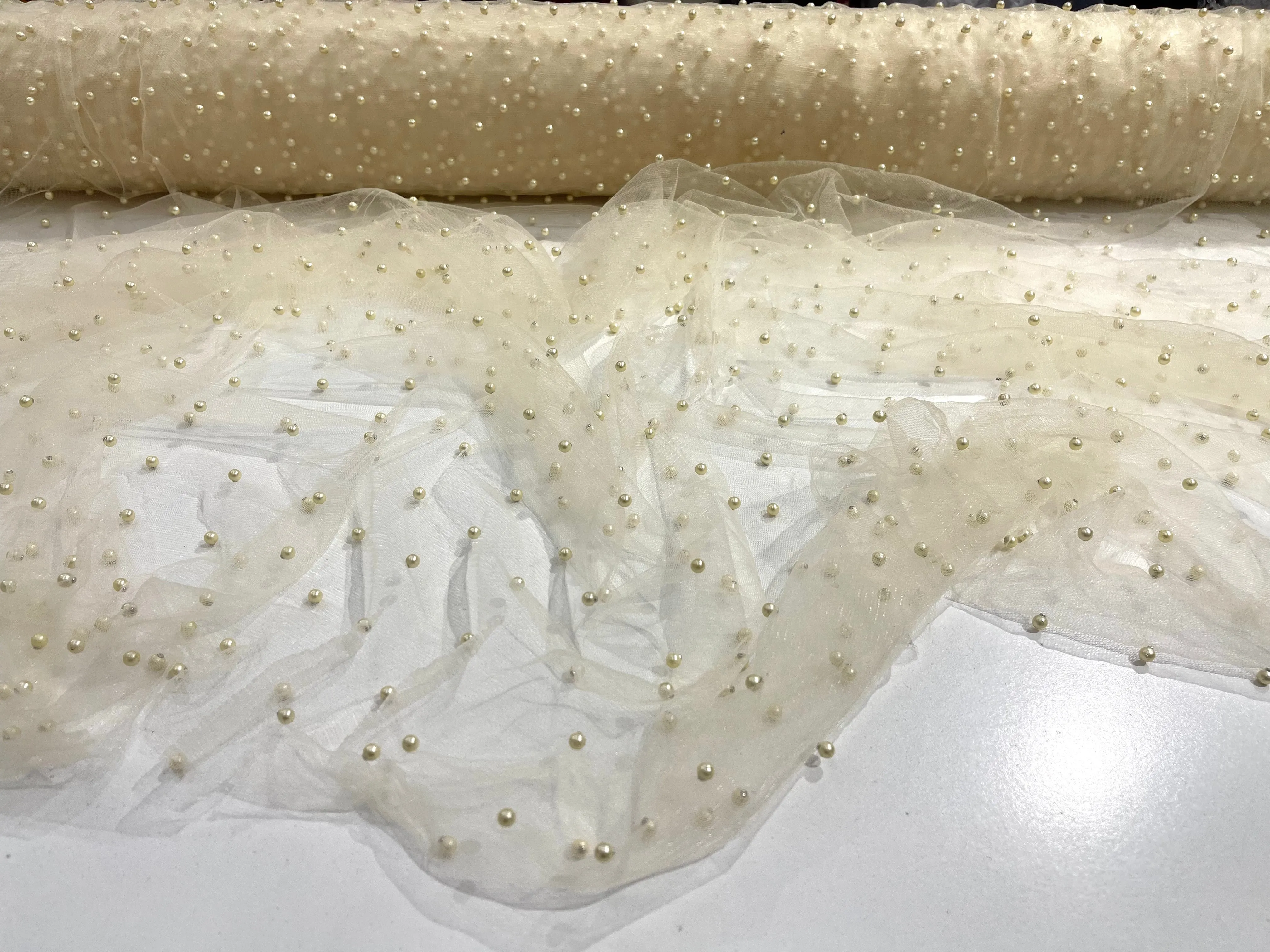 Ivory Scattered Pearls Studded Mesh, 2-Way Stretch, sold by the yard.